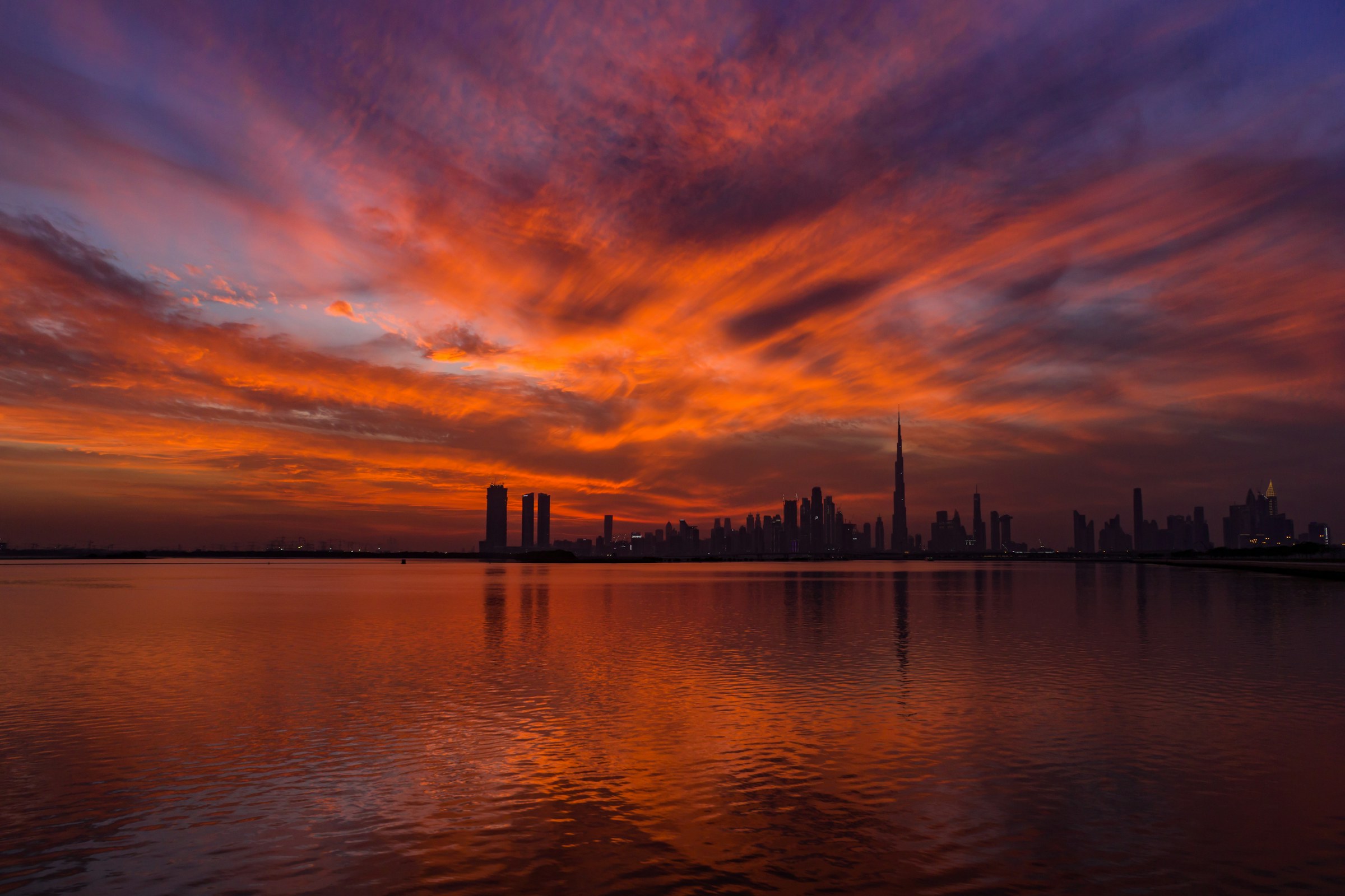 Dubai skyline at sunset across the water
